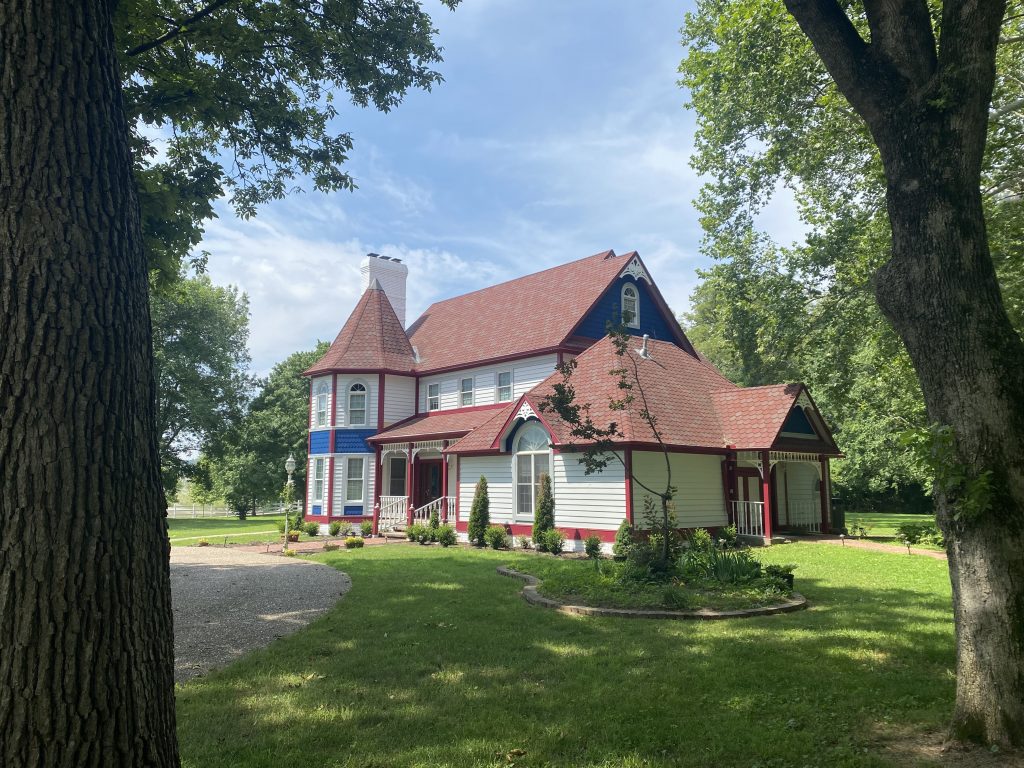 Between the trees, view of our Victorian home.
