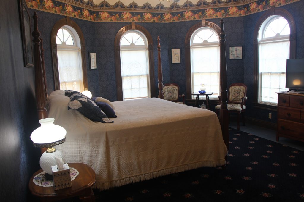 Arthur's Blue Room. King bed, sitting area, nightstand, lamp.
