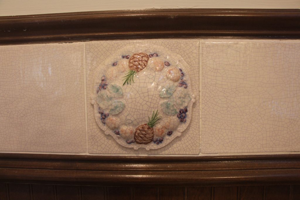 Handmade tile - has pineapples and apples.